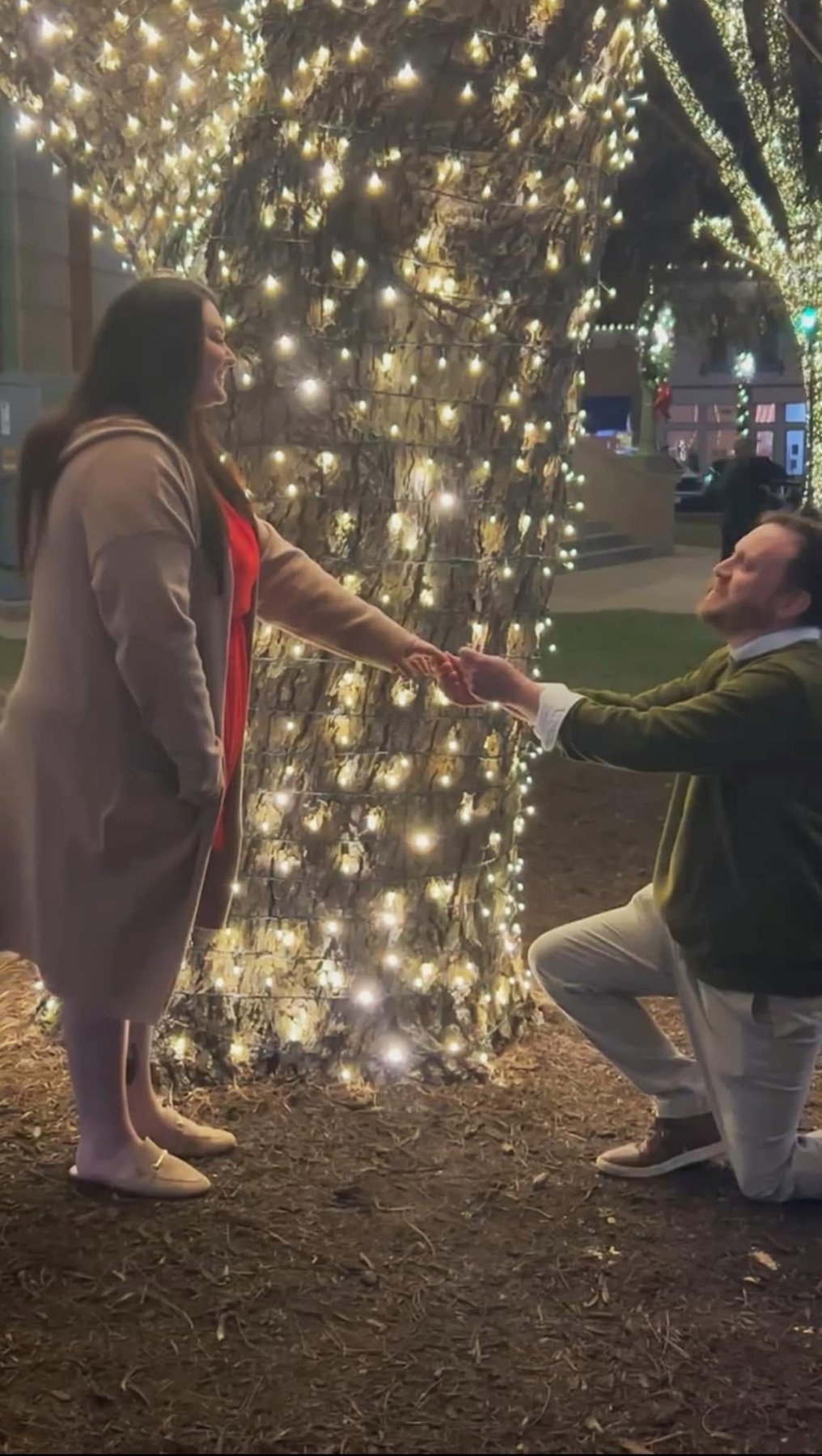 Louis proposing to Cassie under string lights